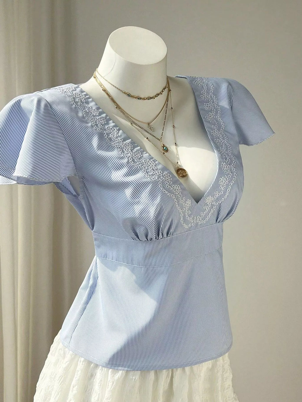Blue Striped V-Neck Blouse with Delicate White Lace Trim